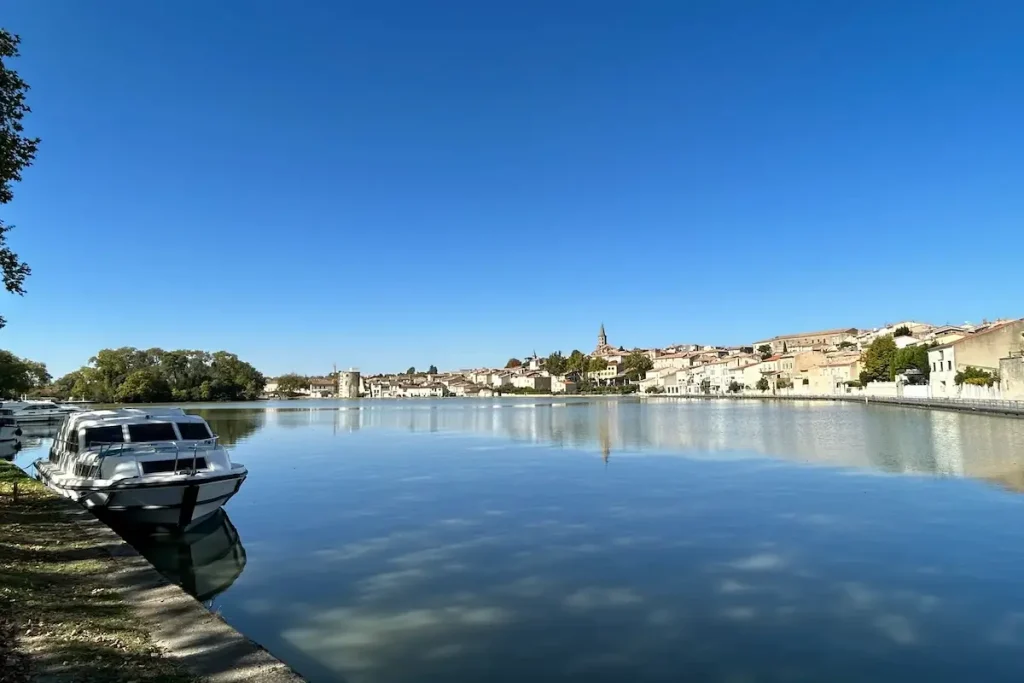 Grand Bassin de Castelnaudary sur le canal du Midi en Occitanie, bateaux amarrés et vue sur la ville